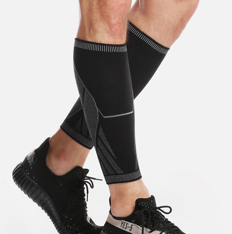 Runner wearing black KINETRA calf sleeves with reflective trim