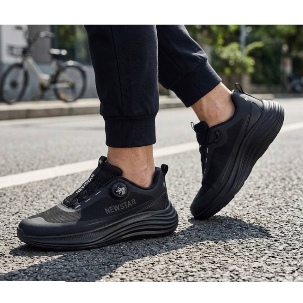NEWSTAR black running shoes worn on a street